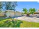 A spacious two-car garage, showcasing ample parking with a basketball hoop and lush tropical landscaping in the surrounding area at 8205 Overlook Ne Pl, St Petersburg, FL 33702