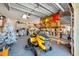 An organized garage featuring a lawnmower, shelving, and overhead storage, maximizing space and functionality for various equipment at 8205 Overlook Ne Pl, St Petersburg, FL 33702