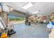 A large, open garage with an overhead door, revealing plenty of storage space and natural light from the opened entrance at 8205 Overlook Ne Pl, St Petersburg, FL 33702