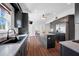 Well-lit kitchen showcases granite countertops, stainless steel appliances, and dark cabinetry at 8205 Overlook Ne Pl, St Petersburg, FL 33702