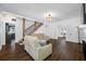 Open living space features hardwood floors, white walls, and a staircase to the second floor at 8205 Overlook Ne Pl, St Petersburg, FL 33702