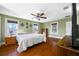 Main bedroom featuring wood floors, a ceiling fan, and natural light at 8205 Overlook Ne Pl, St Petersburg, FL 33702