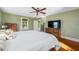 Main bedroom featuring wood floors, a ceiling fan, and natural light at 8205 Overlook Ne Pl, St Petersburg, FL 33702
