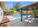 Outdoor oasis featuring a sparkling pool, covered area, tropical landscaping, and a welcoming atmosphere at 8205 Overlook Ne Pl, St Petersburg, FL 33702