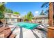Inviting backyard pool with lounge chairs and lush landscaping at 8205 Overlook Ne Pl, St Petersburg, FL 33702
