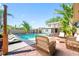 Inviting outdoor area with a sparkling pool, lounge chairs, and lush tropical landscaping at 8205 Overlook Ne Pl, St Petersburg, FL 33702