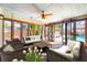 The sunroom features lots of windows and comfortable seating at 8205 Overlook Ne Pl, St Petersburg, FL 33702