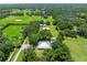 Expansive aerial view of a home surrounded by lush greenery and mature trees on a large property at 9017 S County Line Rd, Lithia, FL 33547