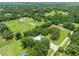 Aerial view of the home on a large lot with mature trees and expansive green space surrounding the property at 9017 S County Line Rd, Lithia, FL 33547