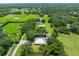 Expansive aerial view of a home surrounded by lush greenery and mature trees on a large property at 9017 S County Line Rd, Lithia, FL 33547