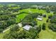 Expansive aerial view of a home surrounded by lush greenery and mature trees on a large property at 9017 S County Line Rd, Lithia, FL 33547
