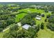 Expansive aerial view of a home surrounded by lush greenery and mature trees on a large property at 9017 S County Line Rd, Lithia, FL 33547