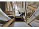 Unfinished attic space featuring exposed beams, spray foam insulation, and storage items at 9017 S County Line Rd, Lithia, FL 33547