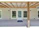 Covered back porch with wood beam supports, providing an ideal spot for outdoor seating and relaxation at 9017 S County Line Rd, Lithia, FL 33547