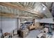 Unfinished basement with exposed wooden ceiling beams, insulation, boxes and household items at 9017 S County Line Rd, Lithia, FL 33547