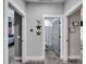 Hallway bathroom featuring neutral walls, grey door, a toilet, and a shower with a white curtain at 9017 S County Line Rd, Lithia, FL 33547