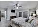 Stylish primary bedroom featuring a flat-screen television and en-suite bathroom at 9017 S County Line Rd, Lithia, FL 33547