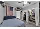 Spacious bedroom featuring an American flag, ceiling fan, and a closet with shelving at 9017 S County Line Rd, Lithia, FL 33547