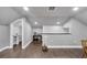 Spacious bonus room boasts wood floors, neutral walls, and a convenient half bathroom, perfect for flexible living at 9017 S County Line Rd, Lithia, FL 33547
