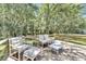 This wood deck features lounge seating and a peaceful view of the property's mature trees at 9017 S County Line Rd, Lithia, FL 33547