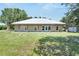 Charming single-story home with a covered front porch and a well-manicured lawn at 9017 S County Line Rd, Lithia, FL 33547