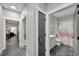 Hallway with doors to the bathroom, bedroom, and laundry room featuring concrete floors and white trim at 9017 S County Line Rd, Lithia, FL 33547