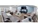 Living room space including a tv, multiple seating options, and built in shelving for storage at 9017 S County Line Rd, Lithia, FL 33547