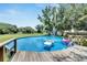This backyard features an above ground pool with a fountain feature and lounge seating at 9017 S County Line Rd, Lithia, FL 33547