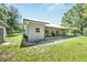 Back of the house featuring a covered patio and green backyard, perfect for outdoor enjoyment and relaxation at 9017 S County Line Rd, Lithia, FL 33547