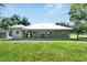 Rear exterior featuring a covered patio, showcasing the home's design and outdoor living spaces at 9017 S County Line Rd, Lithia, FL 33547
