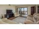 Inviting living room features a neutral color palette, comfortable seating and sliding glass doors to the outdoor balcony at 9860 62Nd N Ter # 1051, St Petersburg, FL 33708
