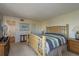 Spacious main bedroom includes soft carpet, a large bed, and a sunny window for lots of natural light at 9860 62Nd N Ter # 1051, St Petersburg, FL 33708