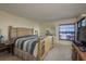 Comfortable main bedroom offers a large window for natural light and an ensuite bathroom at 9860 62Nd N Ter # 1051, St Petersburg, FL 33708