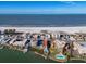 Stunning aerial view showcases condo near beach and ocean, with pool and coastal community at 10301 Gulf Blvd # 302, Treasure Island, FL 33706