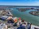 Stunning aerial view of the property showcasing its prime waterfront location and community pool overlooking the bay at 10301 Gulf Blvd # 302, Treasure Island, FL 33706