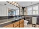 Bathroom featuring dark countertops, wood cabinets, and a walk-in shower at 10301 Gulf Blvd # 302, Treasure Island, FL 33706