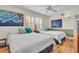Bright bedroom with two beds, ceiling fan and shuttered windows at 10301 Gulf Blvd # 302, Treasure Island, FL 33706