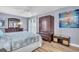 Bedroom with wood floors, a large wardrobe, and an ensuite bathroom at 10301 Gulf Blvd # 302, Treasure Island, FL 33706