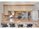 Well-lit kitchen boasts granite countertops, stainless steel appliances, and breakfast bar with seating at 10301 Gulf Blvd # 302, Treasure Island, FL 33706
