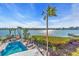 Backyard featuring a pool, seating area, and water view at 10301 Gulf Blvd # 302, Treasure Island, FL 33706