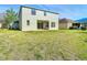 Expansive backyard with lush green grass extending from the back patio to the property line at 10818 Breaking Rocks Dr, Tampa, FL 33647