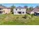 The backyard features a well-maintained lawn, complemented by the view of neighboring homes at 10818 Breaking Rocks Dr, Tampa, FL 33647