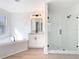 Contemporary bathroom features a soaking tub and glass-enclosed shower at 10818 Breaking Rocks Dr, Tampa, FL 33647