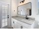 Bright bathroom showcasing granite countertops, sleek vanity and black hardware at 10818 Breaking Rocks Dr, Tampa, FL 33647