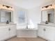 Stylish bathroom features dual sinks and a corner soaking tub for relaxation at 10818 Breaking Rocks Dr, Tampa, FL 33647
