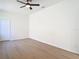 Spacious bedroom featuring light wood floors, neutral walls and a ceiling fan at 10818 Breaking Rocks Dr, Tampa, FL 33647