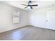 Bright bedroom shows a ceiling fan, floors, window, and closet at 10818 Breaking Rocks Dr, Tampa, FL 33647