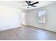 Bright bedroom features sleek ceiling fan, wood-look floors, and a window at 10818 Breaking Rocks Dr, Tampa, FL 33647