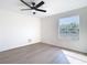 Bright bedroom boasts a ceiling fan, wood-look floors, and a great window view at 10818 Breaking Rocks Dr, Tampa, FL 33647