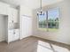 Dining area with a window, white cabinets, and granite countertops providing outdoor views and natural light at 10818 Breaking Rocks Dr, Tampa, FL 33647